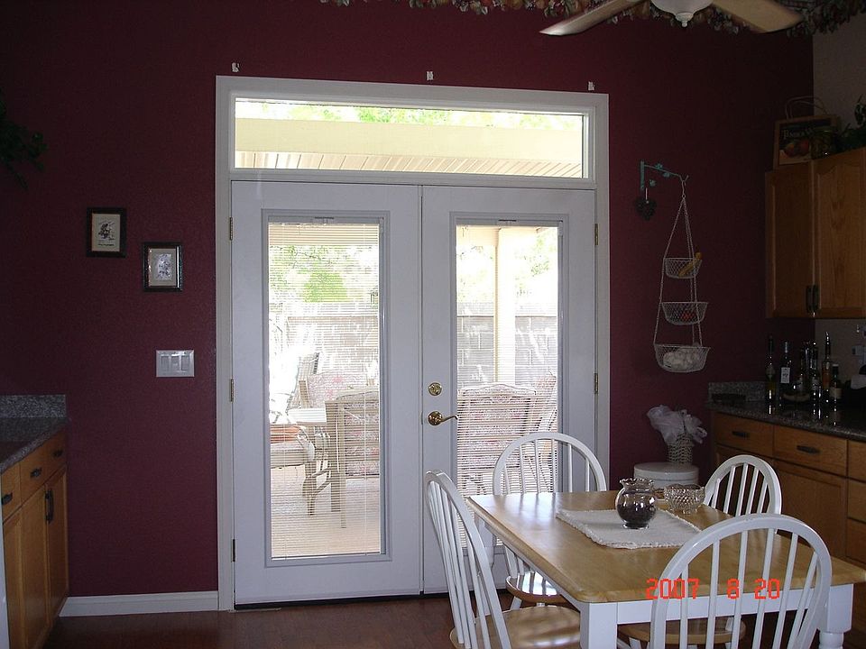 Kitchen with new French doors with blinds between glass