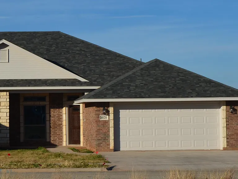 front of house, with sidewalk for a quiet stroll through the gated neighborhood.