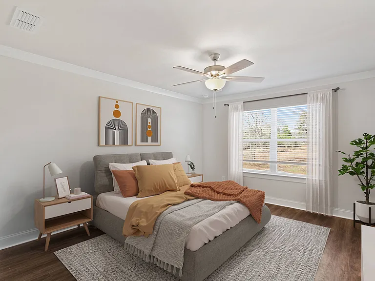 Primary Bedroom with king size bed and large window letting in nice natural light.