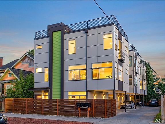 Modern exterior with oversized windows and roof deck