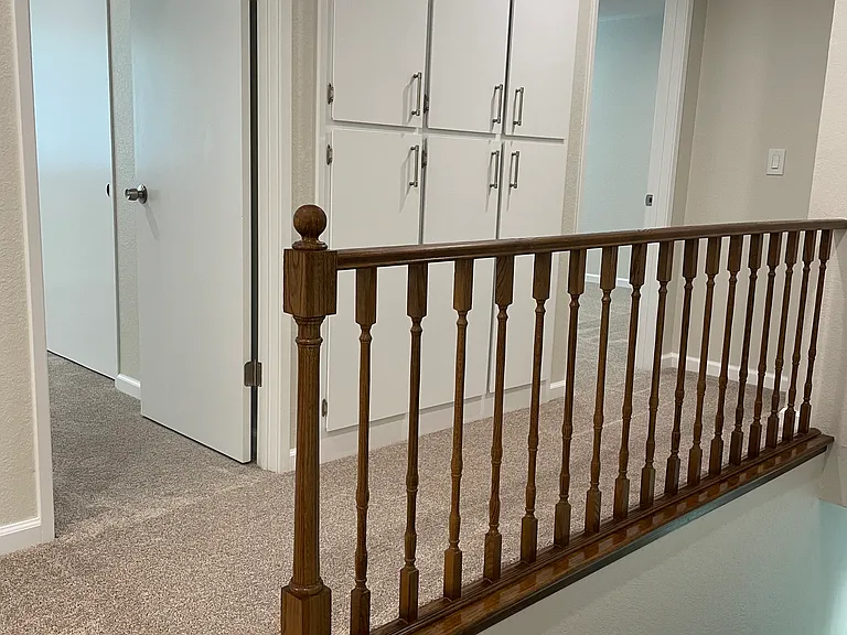 Hallway - more linen cabinets with lots of storage space. Bedroom 2 on left, Bedroom 3 on right.