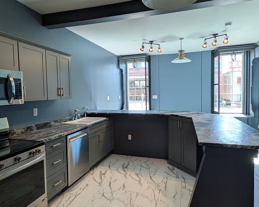 New Kitchen Appliances Including Electric Range, Microwave, Dishwasher and Stainless Refrigerator.