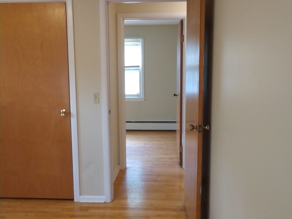 Master bedroom looking past hall into second bedroom.