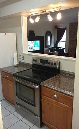 View of the Recent Kitchen Countertops and Range Looking into the Living Room