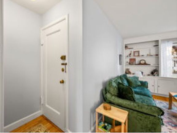 Inside condo entry area includes an entry closet (opposite door - not shown in pic). Right shows entry to living room; opposite is entry to eat-in kitchen.