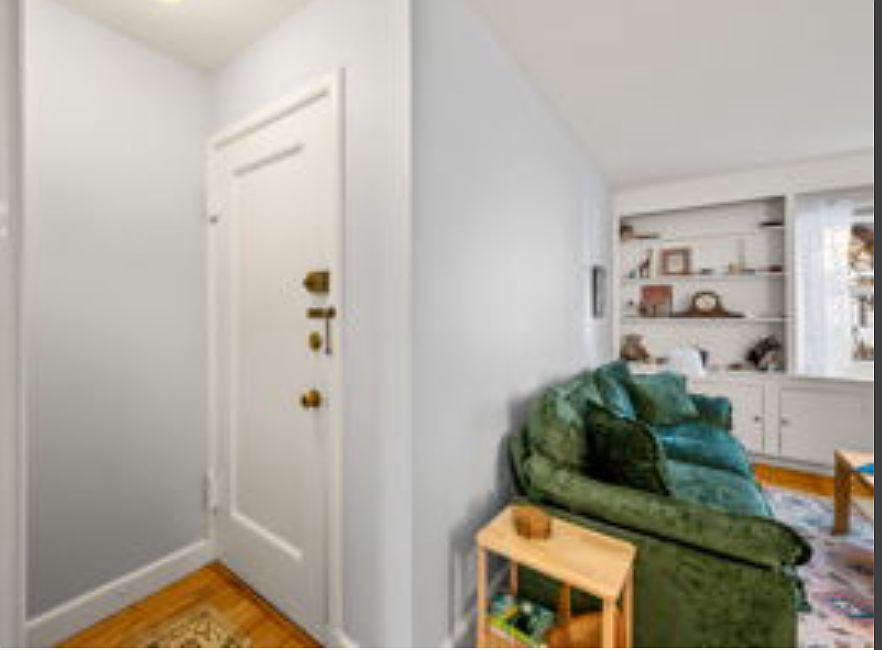 Inside condo entry area includes an entry closet (opposite door - not shown in pic). Right shows entry to living room; opposite is entry to eat-in kitchen.