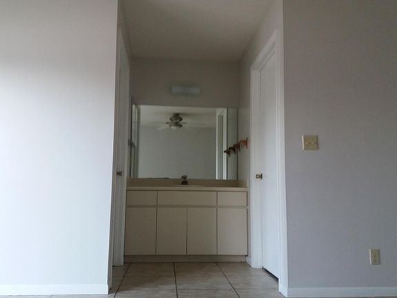 Masters vanity in between bathroom & closet