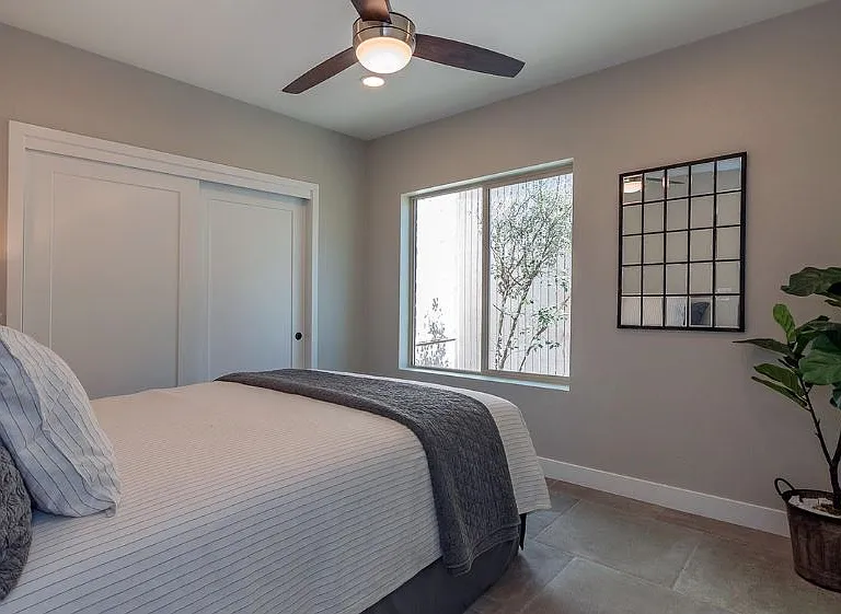 second bedroom looks out to trees near front door - private entrance