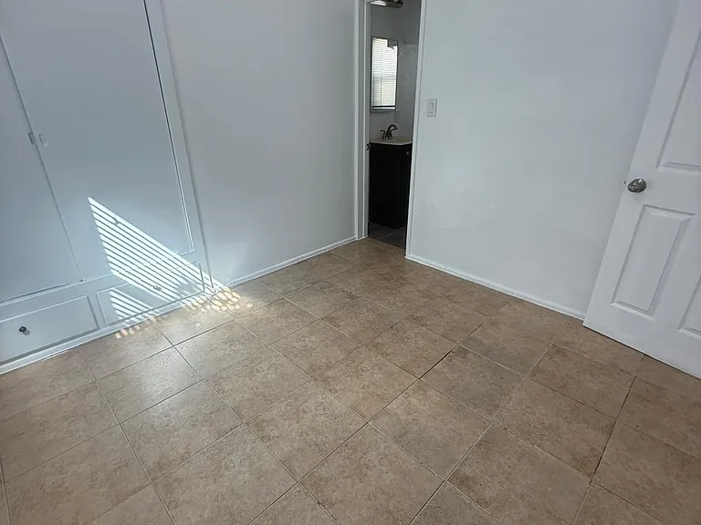 another view of bedroom into bathroom