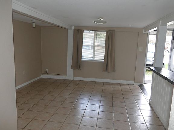 Living room. Breakfast bar/pass- through to kitchen on right. Central air and heat (utilities not included).