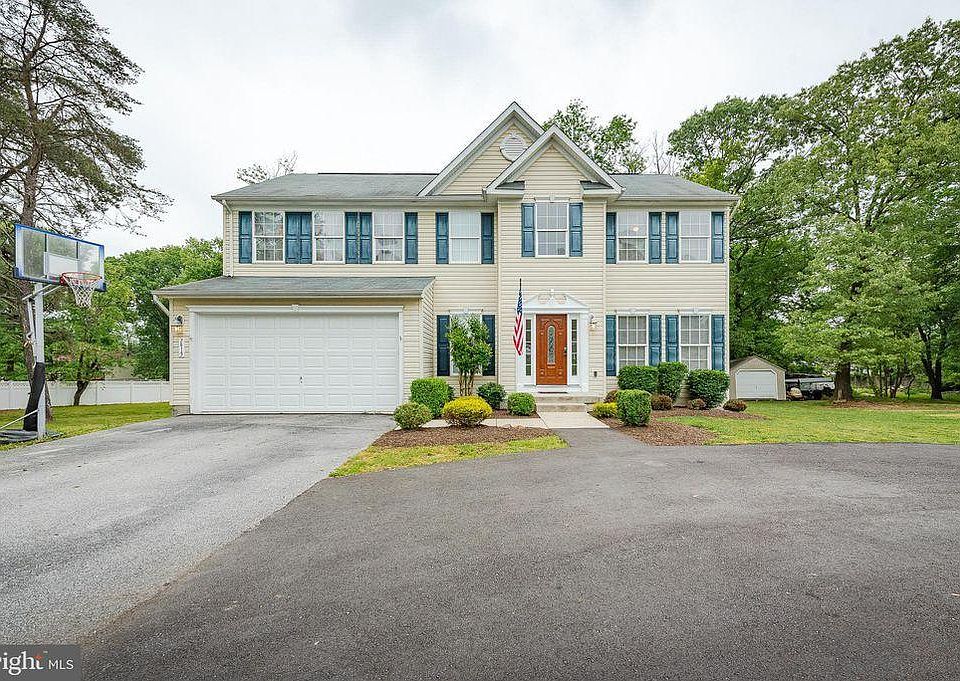Front of Home with Two Car Garage and Circular Driveway