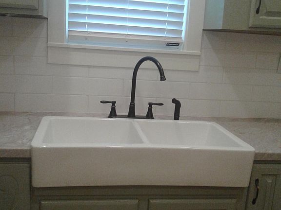 farm sink w/ white tile back splash