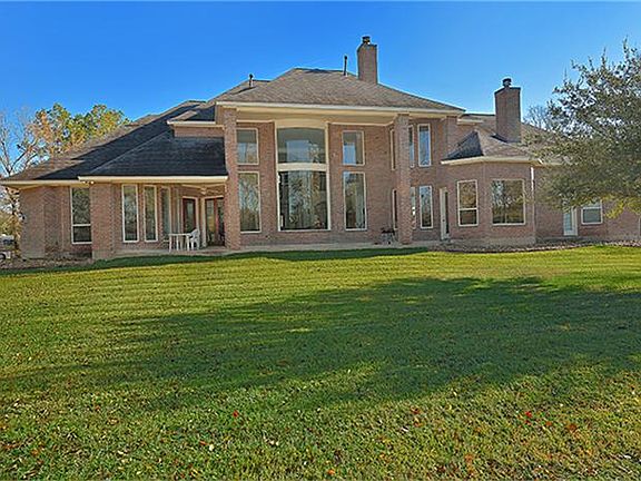 View of back of home showing abundant windows and room for a pool, guest house, tennis courts and more!