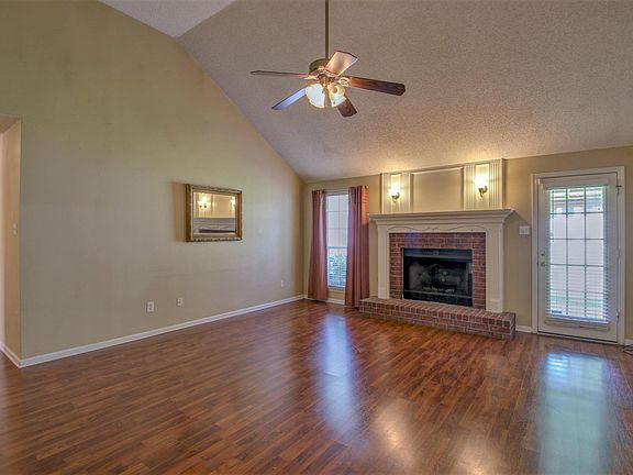 Cozy gas fireplace and french door to the covered patio.