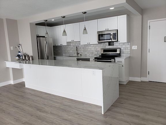 Updated kitchen with new cabinets, granite countertops, and stainless steel appliances
