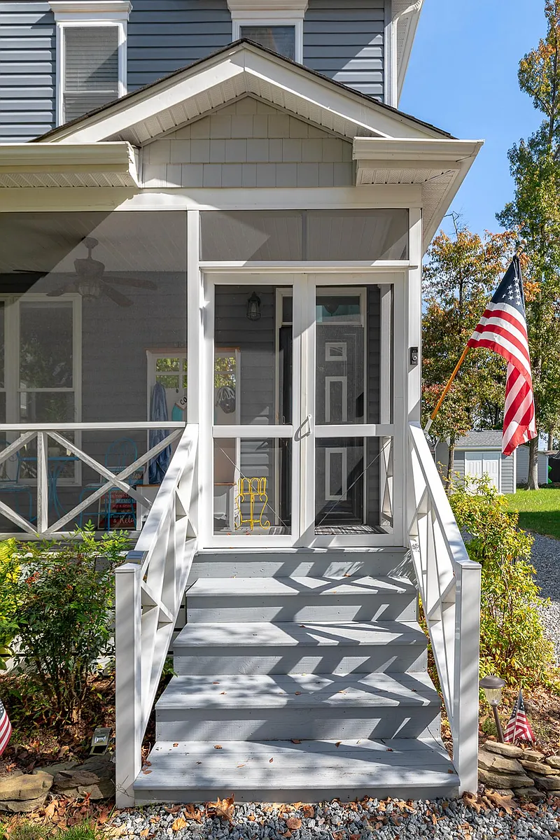 Enjoy relaxing on the three season front porch. A great place to start or end the day. - 1214 Bancroft Ave