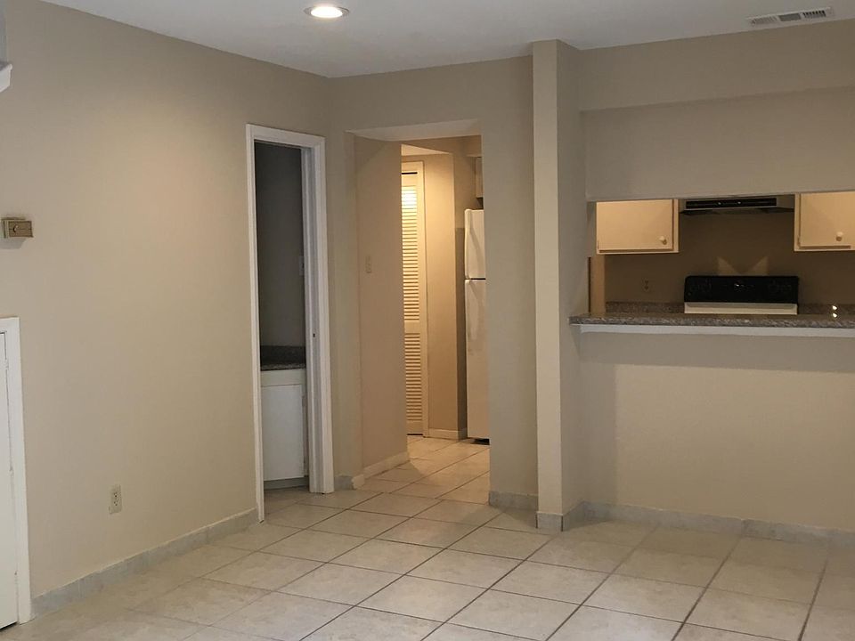 Living room with view of kitchen and half bathroom