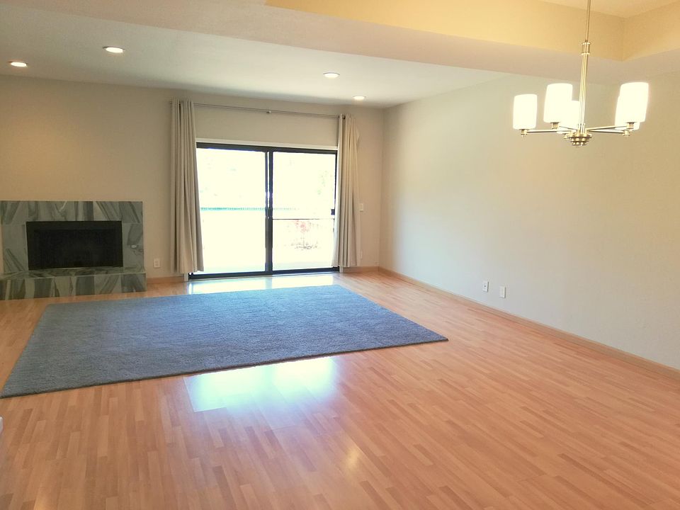 Bright and airy living space with fireplace that flows out t