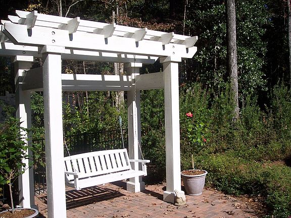 Pergola with Swing in fenced yard