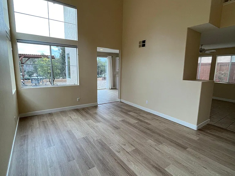 Spacious living room with high ceilings and plenty of light from the large windows