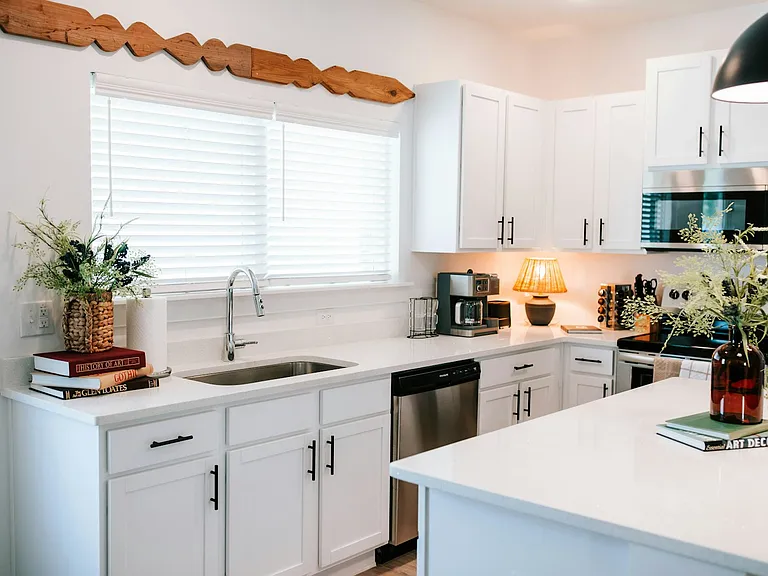 Pendant lights, open layout, and all the amenities. This space is designed for cooking, chatting, and relaxing.