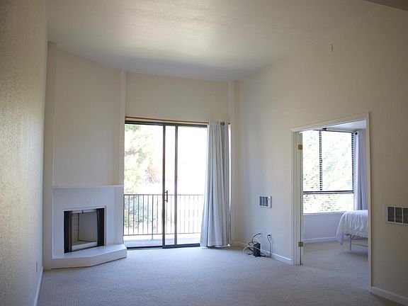 High ceilings, new carpet and paint and private balcony overlooking the gardens. Large bedroom to the right.