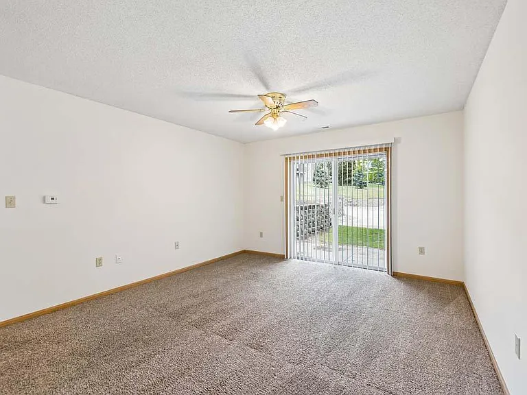 Natural light and sliding glass doors create a bright, comfortable living space with seamless access to the outdoors.