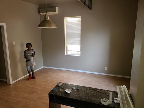 standing in kitchen taking pic of room
