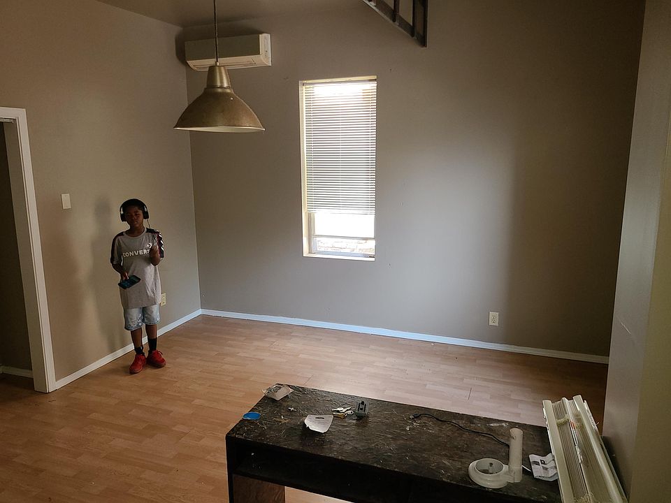 standing in kitchen taking pic of room