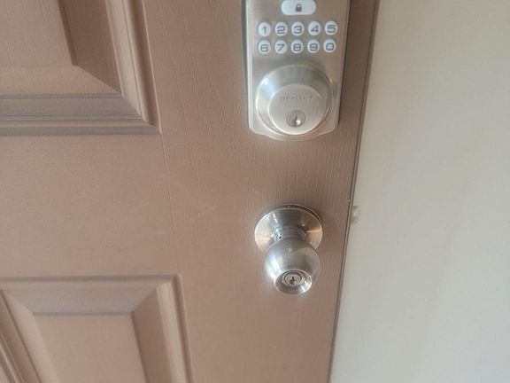 Front door has an electronic keypad.