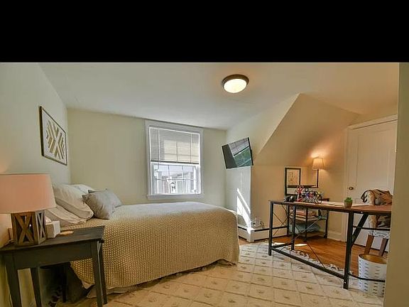 Spacious 2nd bedroom with closet.hardwood floors and good natural light
