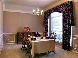Dining space has triple crown molding, chair rail,freshly painted.. larger enough for a table of 12 