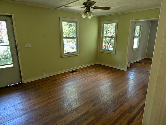View from the hallway into the front yard, living room and dining room