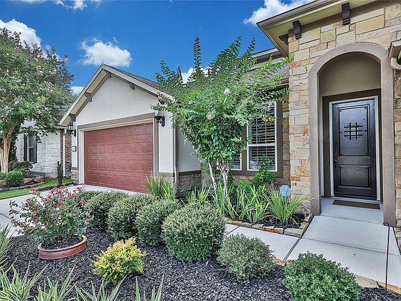Beautiful stone and stucco exterior. The rich mahogany front door and arched entrance welcomes visitors.