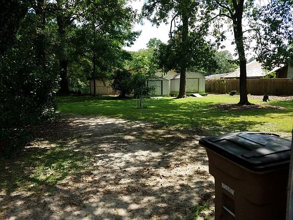 Large fenced yard with 2 storage buildings