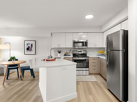 Two-toned white and wood-grain flat front cabinets