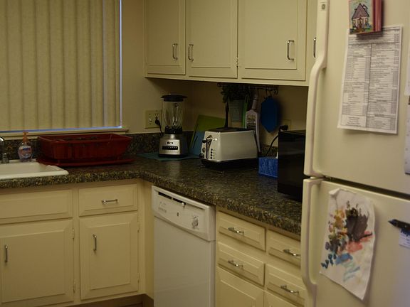 Kitchen with dishwasher and fridge.