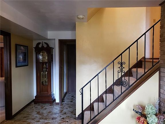 Straight back is full bath and laundry room....stairs lead to Living Room..left opening to Gameroom and wet bar area