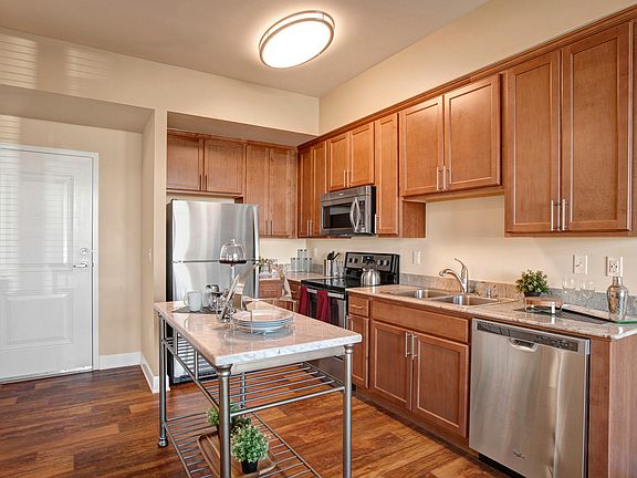Kitchen with island, stainless steel appliances, and plenty of cabinet storage space