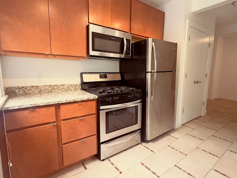 Kitchen with Stainless Steel Appliances and Modern Light Fixture
