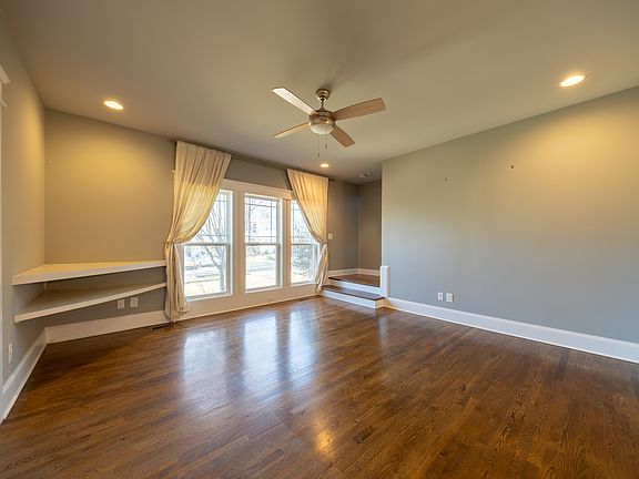 Main floor living room - dramatic windows and built-in TV stand