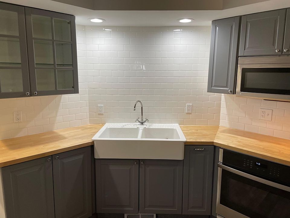 Kitchen, farmhouse sink and beautiful subway tile back splash.