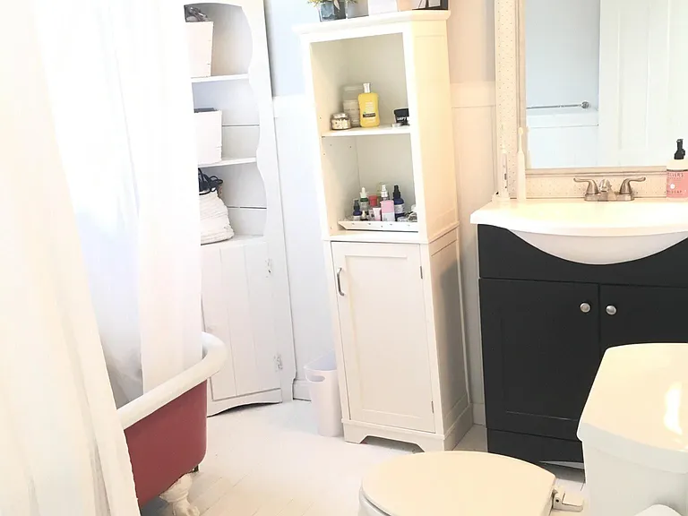 Full bathroom has plenty of storage.