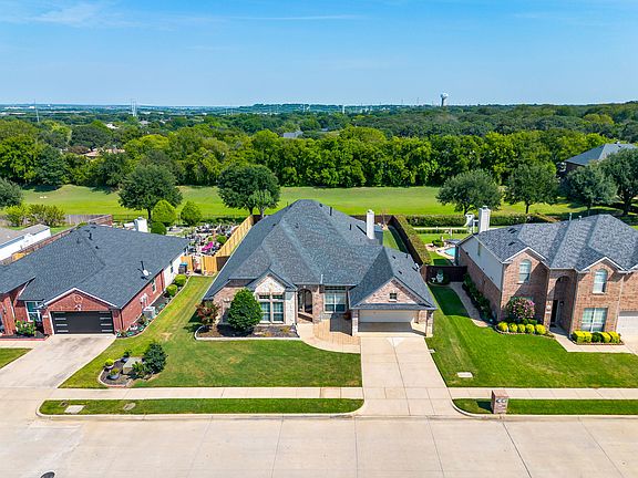 Aerial view of the house with the green belt behind the property