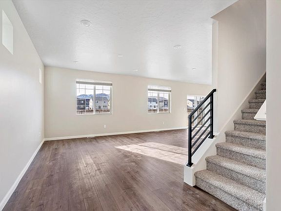 A view of the great room and stairwell from the entry