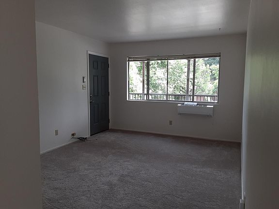 Living room facing front door and window.