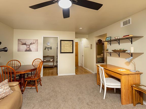 Entry has large coat and storage closet with vacuum and broom.