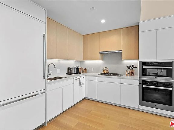 State-of-the-art Miele stainless steel appliances. Light gray marble countertops.