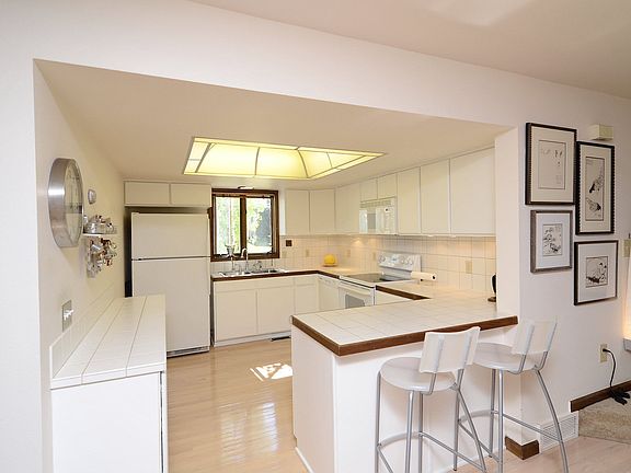 Open kitchen with glass o'wine guest seating