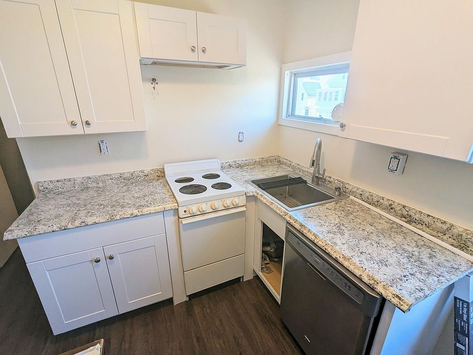 Feature - packed kitchen with beautiful waterproof flooring! No fumbling for a light switch - motion sensor lighting. Finishing touches in-work, fan over range added after this picture taken. Refrigerator also included, not shown.